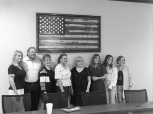 Employees pose with family and friends.