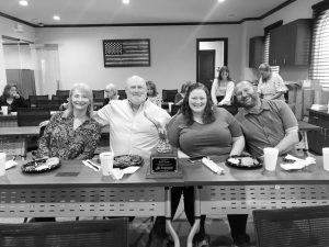 Jeff Hess (center left) enjoys barbeque with his loved ones.