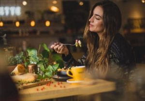 Woman enjoying a meal with a food intolerance