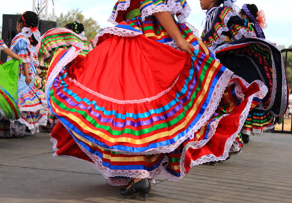 Traditional Mexican dress being twirled during Cinco de Mayo celebration.