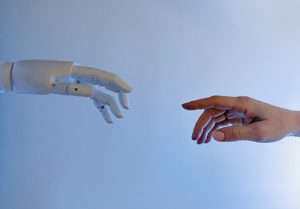 robot and human hands touching as future workforce concept.