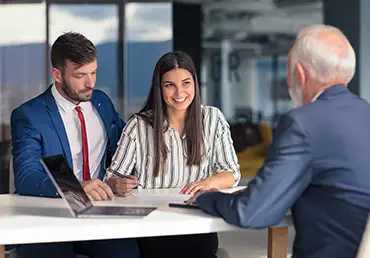 A young couple meets with their financial advisor.